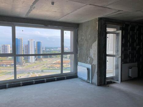 New apartment, new building without finishing and repair, with free planning and walls made of concrete, bricks and gas silicate blocks without partitions and with large panoramic windows photo