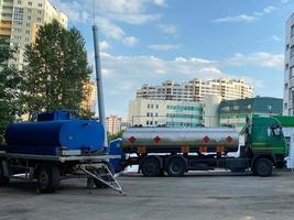 Large industrial truck with a tank, a fuel tanker at a gas station for the transportation of fuel oil, gasoline and diesel photo