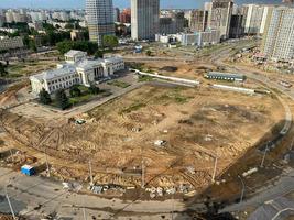 A view from a height of a large modern construction site of tall large houses and multi-storey buildings. A construction site for the development of a new microdistrict in a big city photo