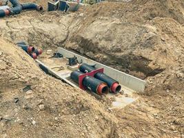 construction of a drainage system in residential buildings. wide black pipes on a concrete gray foundation. laying sewers photo