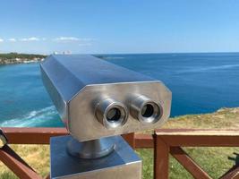 Binoculars on the observation deck overlooking the sea photo