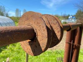 Rusty iron metal industrial pipe of large diameter old with holes for pumping liquid and construction in an oil refinery, petrochemical plant photo