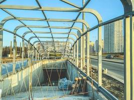 construction of an underpass in the city center. the concrete structure is fenced off from the passage of tourists and residents. crossing without roof and doors photo