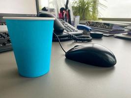 Modern workplace with laptop computer, coffee cup and office supplies photo