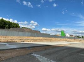 Large industrial mobile concrete plant for building houses behind a fence against a blue sky photo