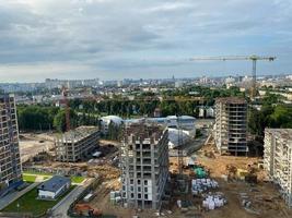 A view from a height of a large modern construction site of tall large houses and multi-storey buildings. A construction site for the development of a new microdistrict in a big city photo