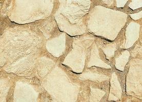 the stone is natural, the path is lined with stones for the convenience of tourists. natural beige texture. large stones of different colors to create roads photo