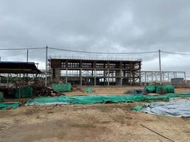 reinforced concrete structures of the building under construction. scaffolding and support. construction crane photo