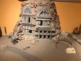 A small clay model of an ancient building in a museum photo