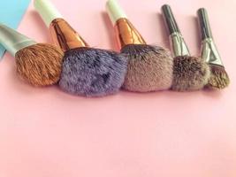 brushes lie on a bright background. fluffy brushes with natural bristles for applying textures to the face. powder, blush and contour brushes photo