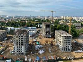 A view from a height of a large modern construction site of tall large houses and multi-storey buildings. A construction site for the development of a new microdistrict in a big city photo