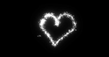 A heart from a flying comet salute love from particles and lines of luminous shiny gold on a black background for Valentine's Day. Abstract screensaver photo