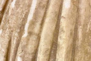 ancient texture. a stone of beige color, a piece of a statue. volumetric texture of stone and sand. a piece of stone cloth photo