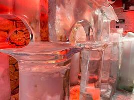 Large transparent winter ice sculptures and figures, columns at the festival. photo