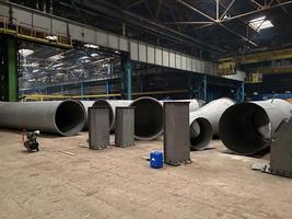 Production of large diameter steel pipes at a metallurgical plant. Soft focus. Close-up photo