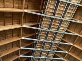 Inside view of working process of building house with wall made from foamed concrete block and red wooden roof. Concept of construction, remodeling, renovation photo