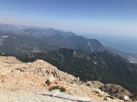 Beautiful landscape view from a high mountain to the forest and mountains in a tropical country with resorts and the sea photo