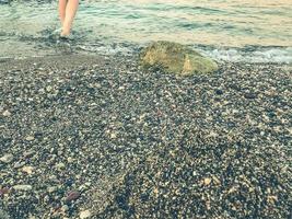 seashore with water and sand. texture, background. tidal bore. wet stones. the waves of the sea wash the shore. 3D texture with stones photo