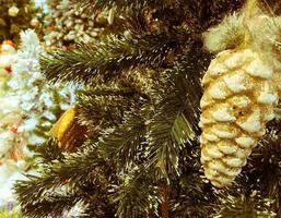 Fir branch with balls and festive lights on the Christmas background with sparkles photo
