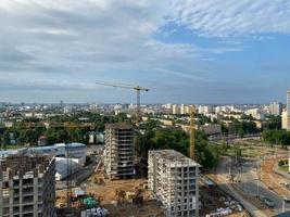 A view from a height of a large modern construction site of tall large houses and multi-storey buildings. A construction site for the development of a new microdistrict in a big city photo