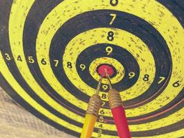 red three darts arrows in the target center business goal concept photo