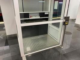 Large new inclusive elevator in the metro or shopping center for people with disabilities and people with disabilities for a barrier-free city environment photo