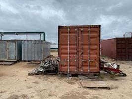 Red large iron metal sea container for the delivery of goods by sea in accordance with the rules of Incoterms 2010 DAP, DDP photo