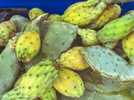 green cactus for eating lies on the counter. trade in exotic food in hot countries. fancy dish, local delicacy, vegan food. healthy diet. vitamin food photo