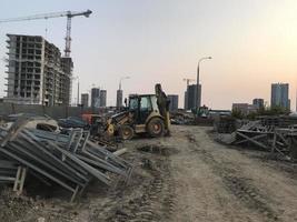 tractor carries construction debris at the construction site. rubbish from concrete, bricks and other construction waste. garbage disposal area photo