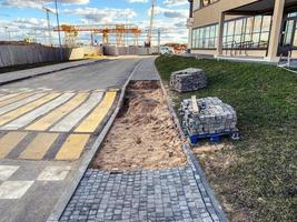 building a pedestrian crossing. construction of a new microdistrict, building material for laying the road and asphalt. marking on asphalt photo