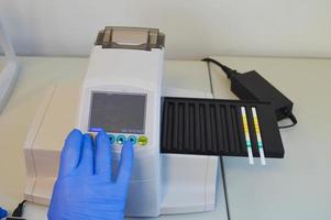 Laboratory technician working with test strips indicator paper photo