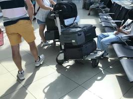 Group of people standing in queue at boarding gate photo