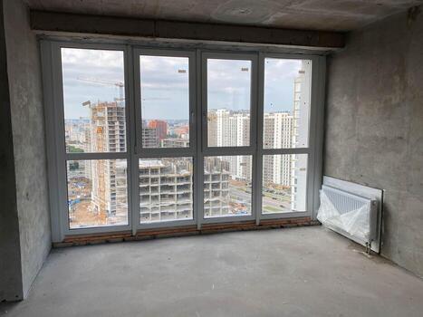 New apartment, new building without finishing and repair, with free planning and walls made of concrete, bricks and gas silicate blocks without partitions and with large panoramic windows photo