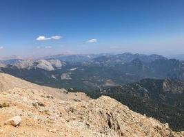 Beautiful landscape view from a high mountain to the forest and mountains in a tropical country with resorts and the sea photo