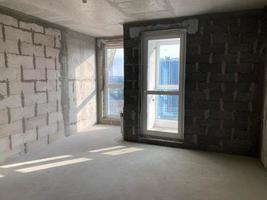 New apartment, new building without finishing and repair, with free planning and walls made of concrete, bricks and gas silicate blocks without partitions and with large panoramic windows photo