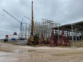 Structure building of steel structure roof truss frame installation by mobile crane under the construction building in the factory with blue sky photo