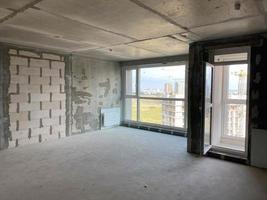 New apartment, new building without finishing and repair, with free planning and walls made of concrete, bricks and gas silicate blocks without partitions and with large panoramic windows photo