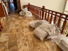 Room cleaning service in the hotel concept. The service room staff laid out bed linen in the hotel corridor for replacement and washing photo