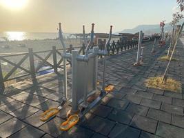 A new modern sports workout area with exercise equipment on the beach on vacation in a warm tropical eastern paradise country southern resort photo