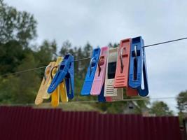 Wash things. clothesline. Clothes pegs. Drying things. Multi-colored clothespins. The photo is suitable for sites selling detergen