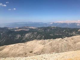 Beautiful landscape view from a high mountain to the forest and mountains in a tropical country with resorts and the sea photo