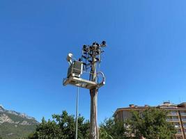 Power line pole with a transformer on it. Typical wooden post from USA photo