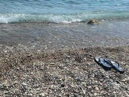 summer women's shoes on sea pebbles. space for text photo