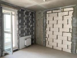 New apartment, new building without finishing and repair, with free planning and walls made of concrete, bricks and gas silicate blocks without partitions and with large panoramic windows photo