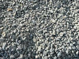 Gray texture of many large sharp hard gray stones, rubble, gravel. The background. Texture photo