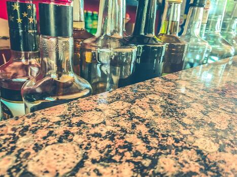 Small liquor production based on maple syrup. Multitude of pure alcohol bottles not labeled. Bottles placed in a row photo