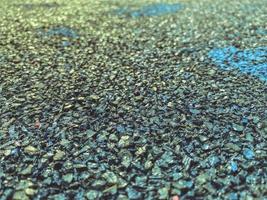 texture, background. black rubberized sports flooring. a field covering from large rubber. safety during active games, anti-slip coating photo