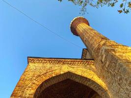 The Islamic mosque is a large Muslim mosque for prayers, an old ancient brick building with a high tower in a tourist warm tropical eastern country southern resort photo