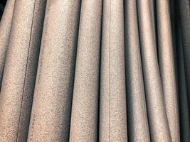 white foam rubber round shape, volumetric foam rubber for construction work. goods in a hardware store for insulation and insulation of pipes. foam pipe with insulation seam photo