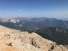 Beautiful landscape view from a high mountain to the forest and mountains in a tropical country with resorts and the sea photo